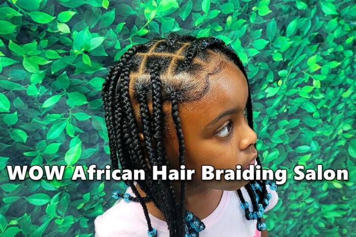 Little girl with medium box braids with beads at kids hair salon.