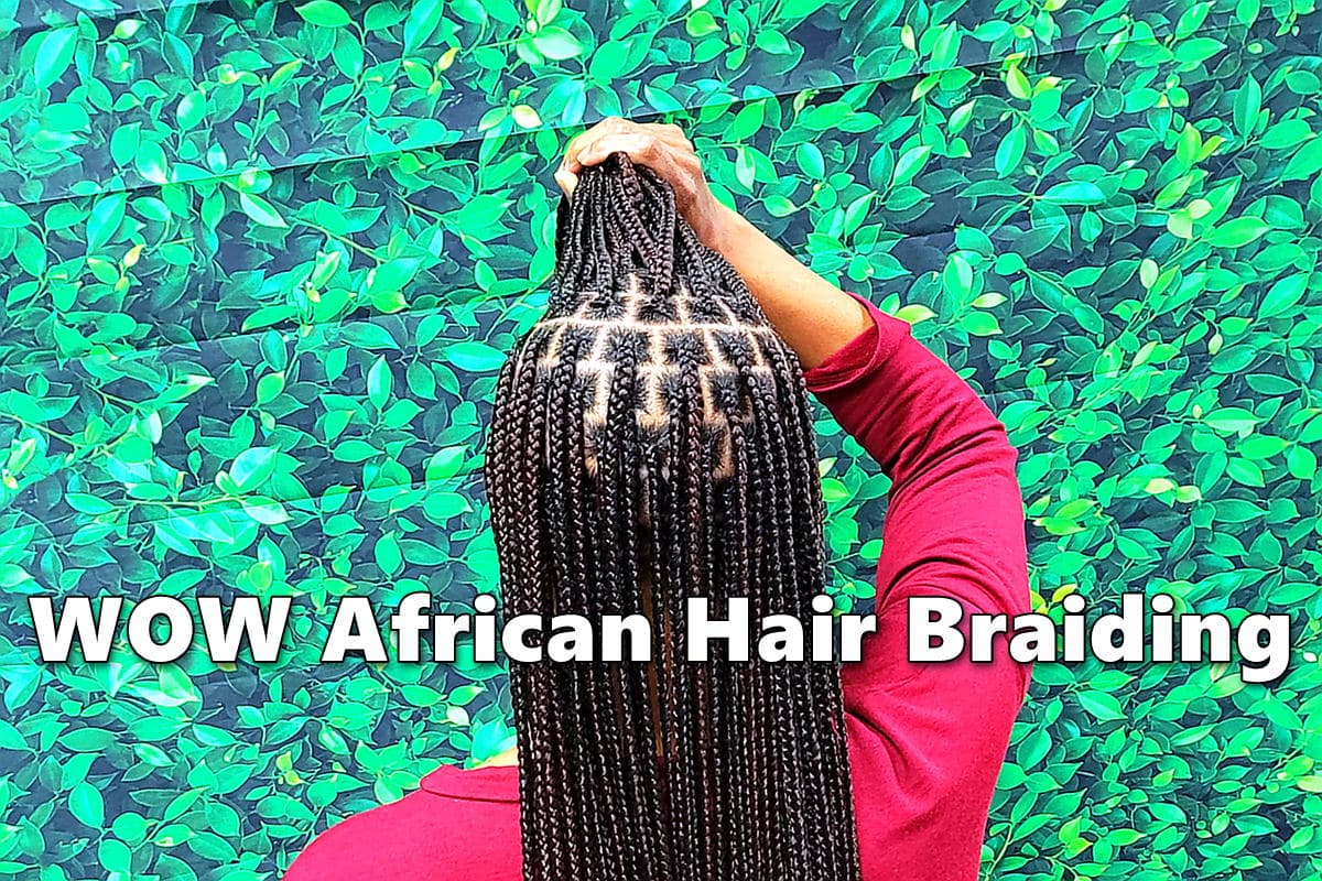 Woman with fresh and clean box braids reminiscent of Zendaya's braids at hair braiding salon.
